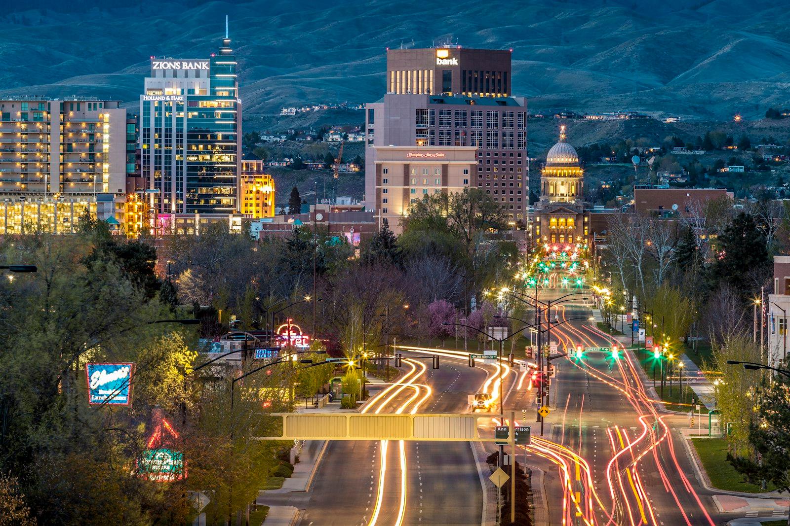 Downtown Boise at dusk with the foothills behind it